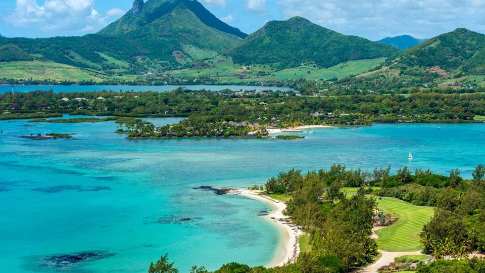 An aerial view of St Regis Mauritius Resort and a huge mountain nearby