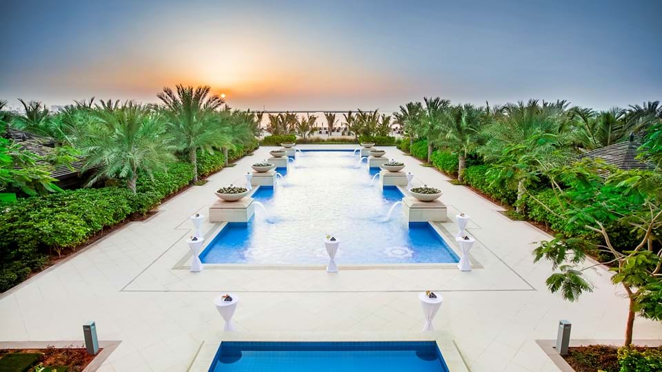 Rich, luscious vegetation skirts this secluded pool looking over sunset at the Waldorf Astoria, Ras Al Khaimah